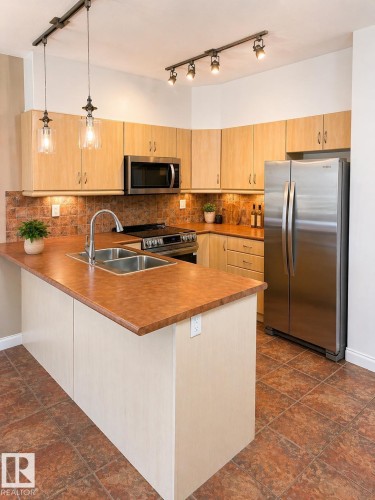 310 1406 Hodgson Way, Edmonton, AB - Indoor Photo Showing Kitchen With Stainless Steel Kitchen With Double Sink