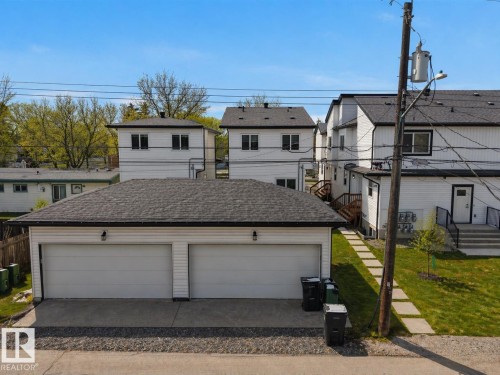 Two-car detached garage with white panel doors and an asphalt shingle roof - 10913 159 Street, Edmonton, AB - Outdoor