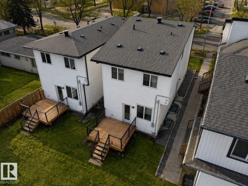 Pair of modern residences featuring white siding and dark shingle roofs - 10913 159 Street, Edmonton, AB - Outdoor