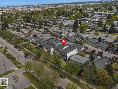 Modern multi-unit residential property with a dark shingle roof and white and dark grey exterior siding - 10913 159 Street, Edmonton, AB - Outdoor With View