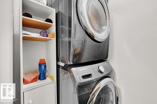 Stacked washer and dryer units - 415 15503 106 Street, Edmonton, AB - Indoor Photo Showing Laundry Room