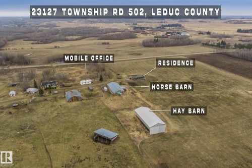 Expansive property featuring a residence, horse barn, hay barn, and mobile office - 23127 Twp Rd 502, Rural Leduc County, AB - Outdoor With View
