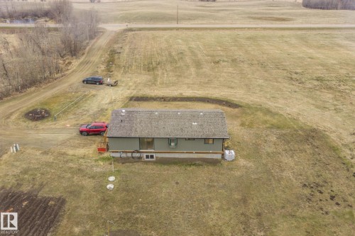 Single-story residence featuring a gray shingle roof and light green siding - 23127 Twp Rd 502, Rural Leduc County, AB - Outdoor With View