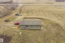 Single-story residence featuring a gray shingle roof and light green siding - 