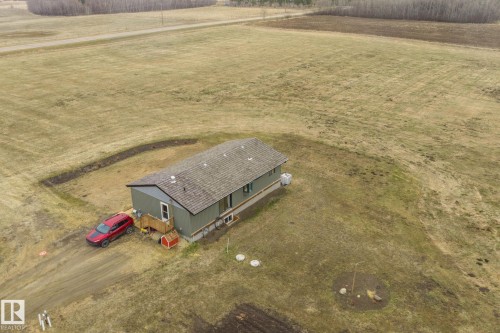 Single-story home featuring a gray exterior and a shingled roof - 23127 Twp Rd 502, Rural Leduc County, AB - Outdoor