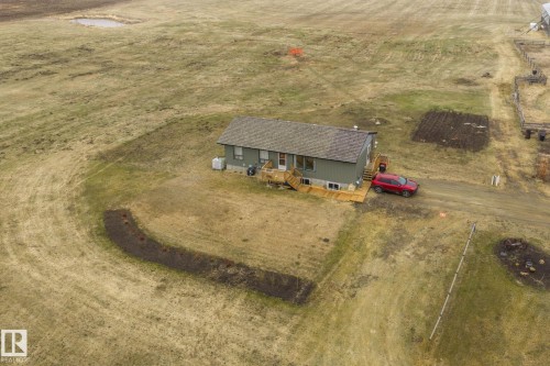 Ranch-style residence featuring a gray exterior with a shingle roof - 23127 Twp Rd 502, Rural Leduc County, AB - Outdoor