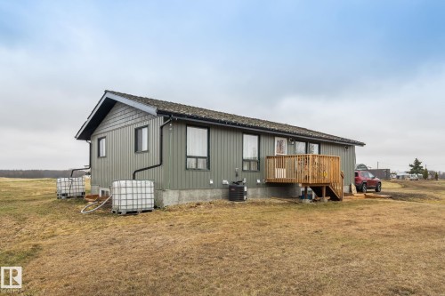 Single-story residence featuring grey vertical siding and dark trim - 23127 Twp Rd 502, Rural Leduc County, AB - Outdoor With Exterior