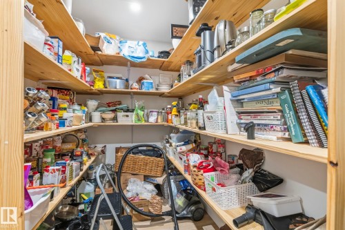 Walk-in pantry featuring extensive wood shelving, recessed lighting, and ample storage space - 23127 Twp Rd 502, Rural Leduc County, AB - Indoor With Storage