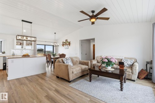 Open-concept living space featuring wood-finish flooring and a white planked vaulted ceiling - 23127 Twp Rd 502, Rural Leduc County, AB - Indoor Photo Showing Other Room