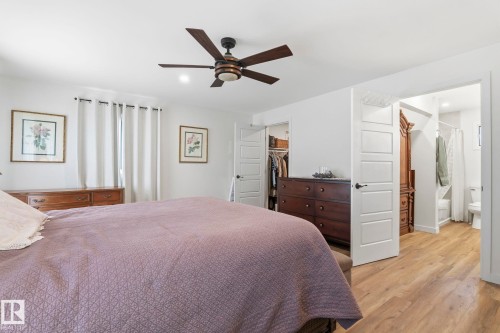 Bright interior space featuring wood-finish flooring, a dark-toned ceiling fan, and recessed lighting - 23127 Twp Rd 502, Rural Leduc County, AB - Indoor Photo Showing Bedroom