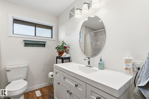 Bathroom featuring a white vanity with shaker-style cabinetry, a single basin sink, and a chrome faucet - 23127 Twp Rd 502, Rural Leduc County, AB - Indoor Photo Showing Bathroom