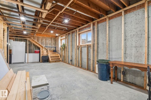 Spacious unfinished lower level featuring exposed wood framing, concrete foundation walls, and a wood staircase - 23127 Twp Rd 502, Rural Leduc County, AB - Indoor Photo Showing Basement
