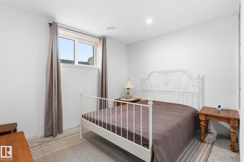 Recessed lighting and a window with neutral drapes illuminate this room with light-toned walls - 23127 Twp Rd 502, Rural Leduc County, AB - Indoor Photo Showing Bedroom