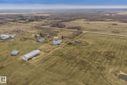 Expansive rural property featuring multiple outbuildings, open fields, and areas of mature trees - 23127 Twp Rd 502, Rural Leduc County, AB - Outdoor With View