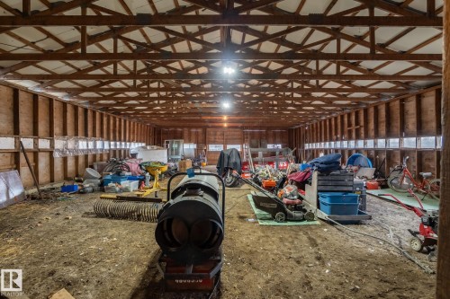 Spacious interior structure featuring exposed timber framing and wood wall paneling - 23127 Twp Rd 502, Rural Leduc County, AB - Indoor Photo Showing Other Room