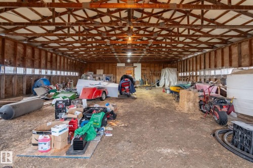 Spacious barn interior featuring exposed wooden rafters and beams - 23127 Twp Rd 502, Rural Leduc County, AB - Indoor Photo Showing Other Room