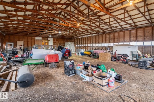 Spacious barn interior featuring exposed wooden rafters and beams - 23127 Twp Rd 502, Rural Leduc County, AB - Indoor Photo Showing Other Room