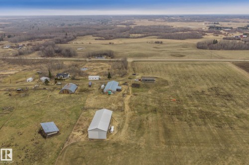 Expansive acreage featuring multiple outbuildings, including a large metal-roofed structure and several smaller sheds - 23127 Twp Rd 502, Rural Leduc County, AB - Outdoor With View