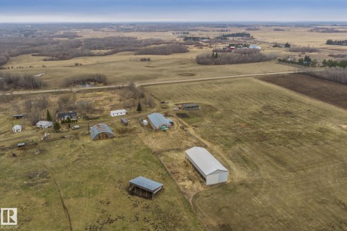 Expansive rural property featuring multiple outbuildings, including a large metal-sided pole barn and a quonset hut - 23127 Twp Rd 502, Rural Leduc County, AB - Outdoor With View