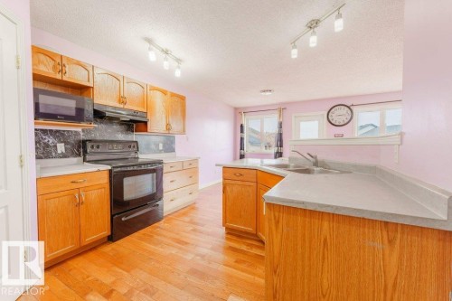 2144 37B Avenue, Edmonton, AB - Indoor Photo Showing Kitchen With Double Sink