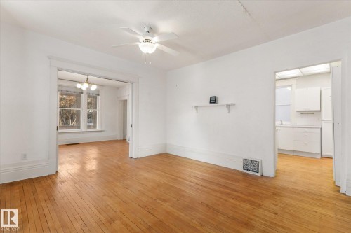 Hardwood flooring throughout, with a ceiling fan light fixture - 10921 126 Street, Edmonton, AB - Indoor Photo Showing Other Room