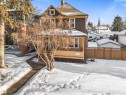 Two-story property featuring a front porch with latticework skirting, a gabled roof, and wood siding - 10921 126 Street, Edmonton, AB  - Outdoor 