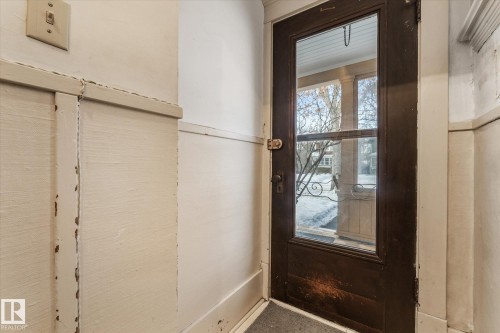 Dark-stained wood-framed glass-paneled door - 10921 126 Street, Edmonton, AB - Indoor Photo Showing Other Room