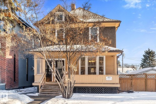 Classic two-story residence featuring a covered front porch, a prominent gable roofline, and a lattice foundation skirt - 10921 126 Street, Edmonton, AB - Outdoor