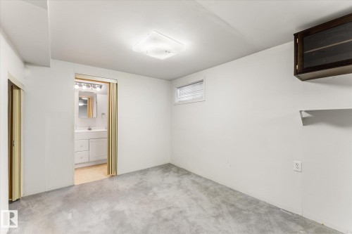 Finished interior space with light gray carpet, recessed window, overhead lighting, and built-in wall cabinet with shelving - 10921 126 Street, Edmonton, AB - Indoor Photo Showing Other Room