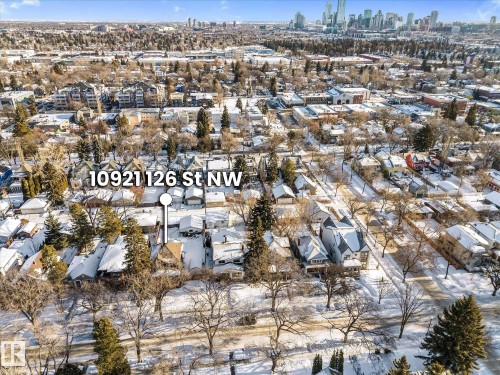 Aerial perspective showcasing a residential neighborhood with snow-covered rooftops and mature trees - 10921 126 Street, Edmonton, AB - Outdoor With View