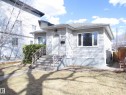 Single-family residence featuring light-colored siding, a sloped roof, and a prominent front entrance with a white door - 12115 64 Street Nw, Edmonton, AB  - Outdoor 