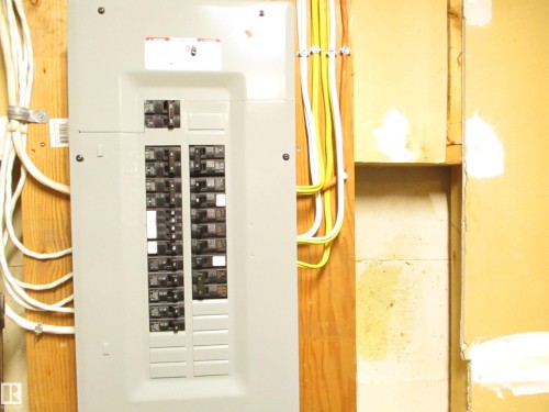 Electrical service panel with multiple circuit breakers - 12115 64 Street Nw, Edmonton, AB - Indoor