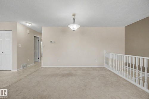 Carpeted open-concept room with neutral wall tones - 1542 54 Street, Edmonton, AB - Indoor Photo Showing Other Room