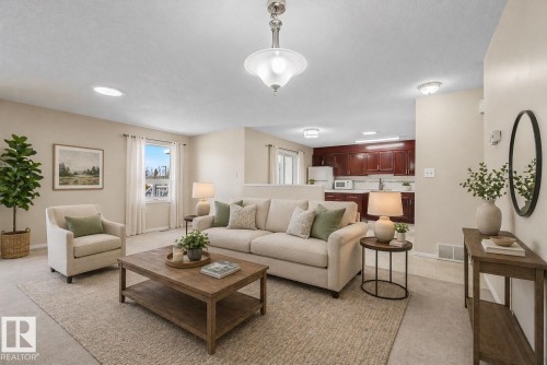 Open-concept common area featuring light-colored carpeting, a neutral wall palette, and recessed lighting - 1542 54 Street, Edmonton, AB - Indoor Photo Showing Living Room