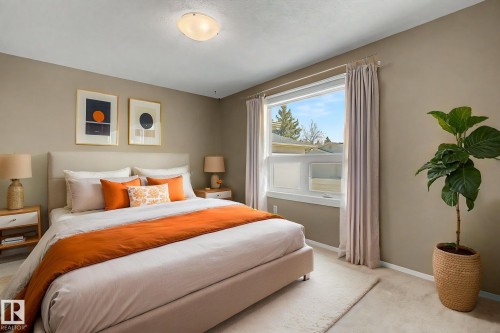 Bedroom featuring neutral wall colors, a large window, and a flush mount ceiling light - 1542 54 Street, Edmonton, AB - Indoor Photo Showing Bedroom