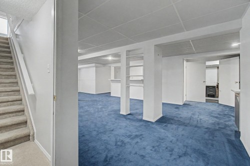 Spacious lower level featuring blue carpeting and recessed lighting - 1542 54 Street, Edmonton, AB - Indoor Photo Showing Other Room