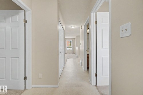 Interior hallway featuring light-toned walls and tile flooring - 1542 54 Street, Edmonton, AB - Indoor Photo Showing Other Room