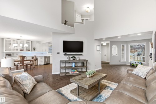 Open-concept living area featuring high ceilings, dark wood-finish flooring, recessed lighting, and a bay window - 14755 131 Street Nw, Edmonton, AB - Indoor Photo Showing Living Room