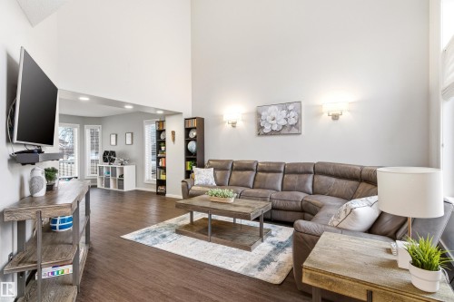 Living area featuring a vaulted ceiling and dark wood-finish flooring - 14755 131 Street Nw, Edmonton, AB - Indoor Photo Showing Living Room