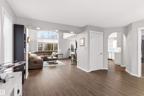 Spacious interior featuring wood-finish flooring, light grey walls, and white trim throughout - 14755 131 Street Nw, Edmonton, AB - Indoor Photo Showing Other Room