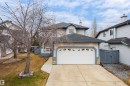 Two-story residence featuring light-colored siding with blue trim accents - 14755 131 Street Nw, Edmonton, AB  - Outdoor 