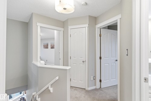Upper-level hallway with neutral wall tones and a flush-mount ceiling light fixture - 14755 131 Street Nw, Edmonton, AB - Indoor Photo Showing Other Room