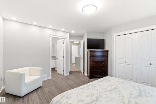 Room featuring wood-finish flooring, recessed lighting, and a contemporary ceiling fixture - 14755 131 Street Nw, Edmonton, AB - Indoor Photo Showing Bedroom