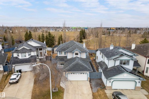 Two-story property featuring a front-facing attached two-car garage, light-colored exterior siding with contrasting trim, and a dark shingled roof - 14755 131 Street Nw, Edmonton, AB - Outdoor