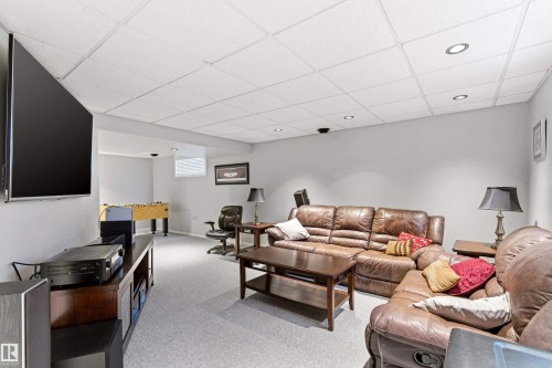 Recreation room featuring recessed lighting, a drop ceiling, and carpet flooring - 14755 131 Street Nw, Edmonton, AB - Indoor