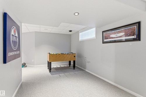 Spacious room featuring light gray walls, recessed lighting, white baseboards, and light-colored carpet flooring - 14755 131 Street Nw, Edmonton, AB - Indoor Photo Showing Other Room