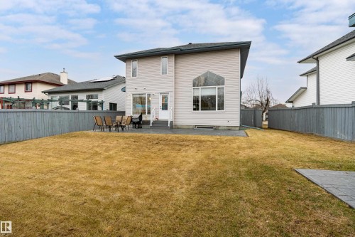 Rear exterior featuring light-colored siding and a dark shingled roof - 14755 131 Street Nw, Edmonton, AB - Outdoor With Deck Patio Veranda With Exterior