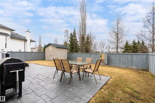 Spacious backyard featuring a stamped concrete patio, a detached storage shed, a privacy fence, and a lawn area - 14755 131 Street Nw, Edmonton, AB - Outdoor With Deck Patio Veranda