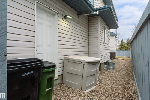 Exterior siding with a side entrance door and overhead wall-mounted light fixture - 14755 131 Street Nw, Edmonton, AB - Outdoor With Exterior