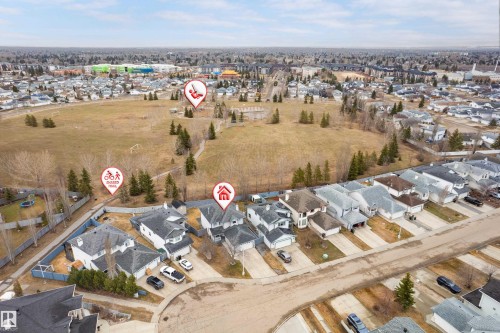 Aerial view of a residential street with detached homes, each featuring individual driveways and front yards - 14755 131 Street Nw, Edmonton, AB - Outdoor With View